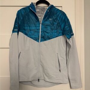 Blue and gray Nike zip up running jacket with hood, size medium